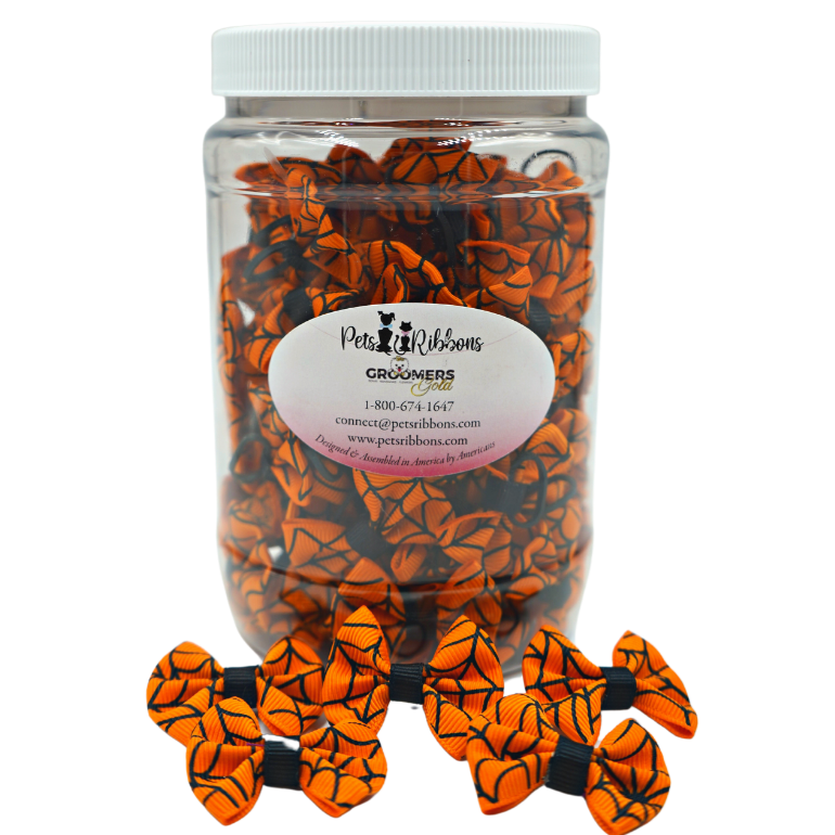 orange spiderweb bows with black trim on rubber bands. dinky bows for dog, cat, pets groomers