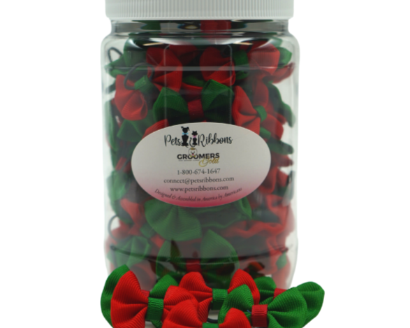Red and green small dog bows on a rubber band in a jar for groomers